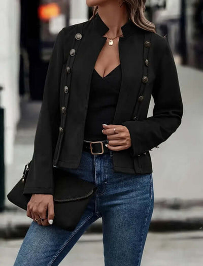Double-row metal buckle black long-sleeved coat paired with jeans, showcasing a retro style for women.