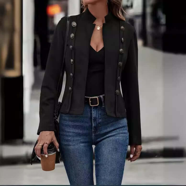 Woman wearing a double-row metal buckle black long-sleeved coat with jeans, holding a coffee cup.