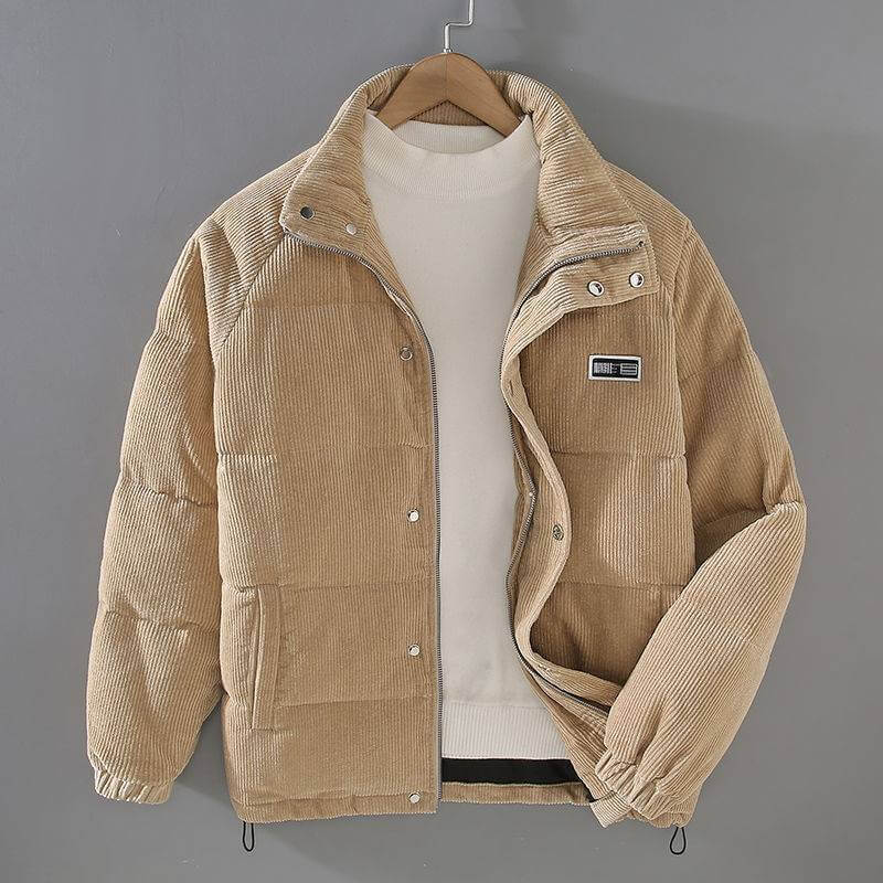 Beige puffer jacket coat with a corduroy texture, featuring a zippered front and a patch pocket.