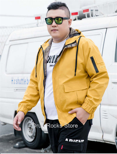 Stylish man wearing a yellow bomber jacket with sunglasses, showcasing casual street fashion.