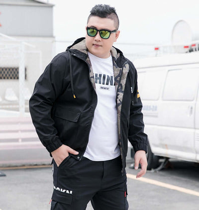 Stylish man in black bomber jacket with sunglasses, showcasing casual streetwear fashion.