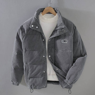 Gray puffer jacket coat for men, featuring a corduroy design and button snaps, perfect for casual outerwear.
