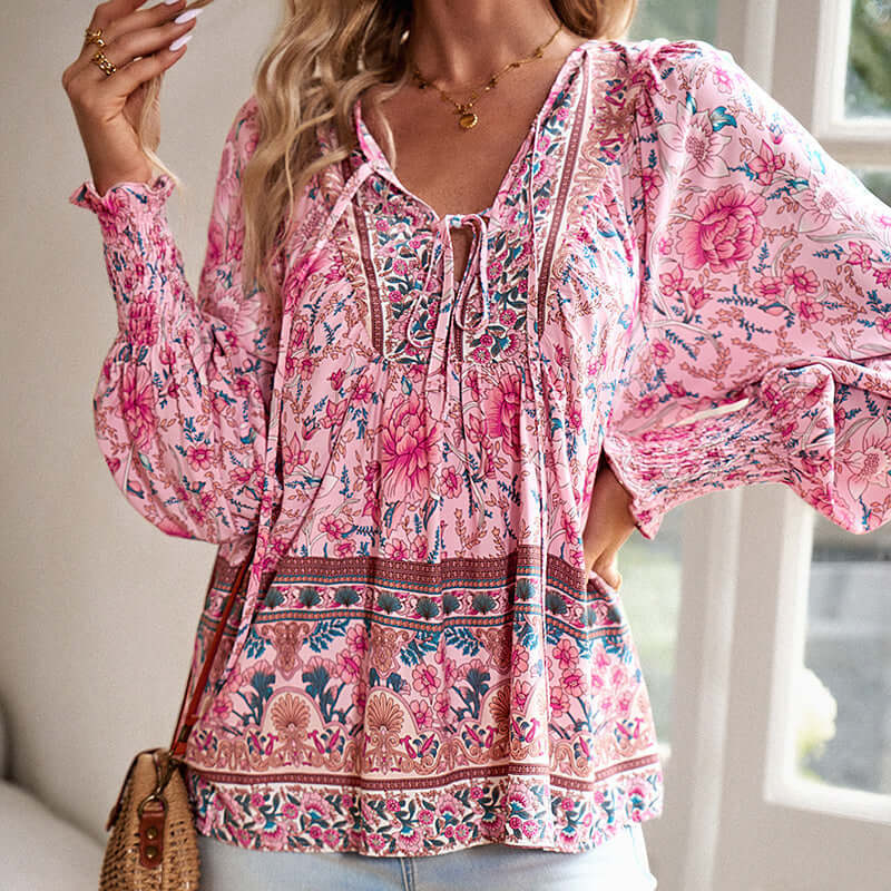 Boho chic long sleeve blouse in pink floral print, featuring a lace-up and drawstring detail for an elegant vacation style.