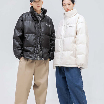 Two models wearing loose down jackets, one in black and one in white, styled for a winter look.