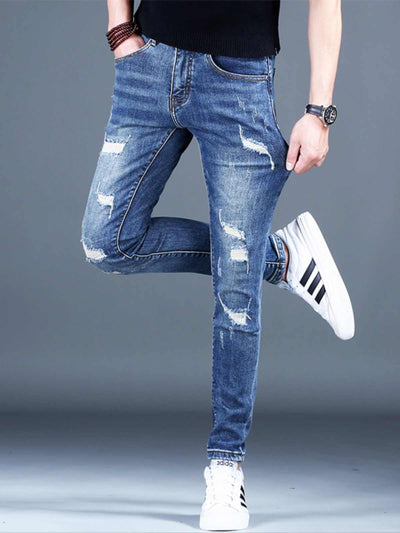 Men's ripped fleece padded jeans in light blue, slim-fit style, showcasing casual wear with distressing details.