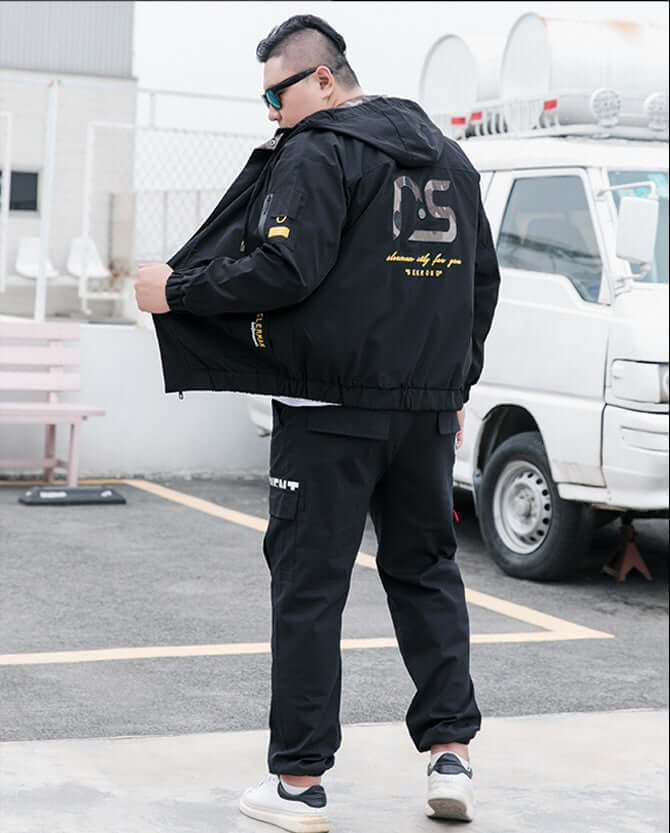 Man wearing a stylish bomber jacket, showcasing a modern urban fashion look.