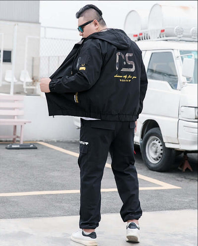 Man wearing a stylish bomber jacket, showcasing a modern urban fashion look.