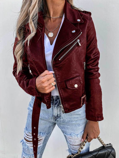 Burgundy PU leather short jacket with zipper, long sleeves, worn with ripped jeans and a casual white top.