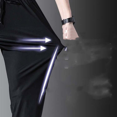 Close-up of breathable thin black straight pants for men highlighting high elasticity and quick-drying fabric.