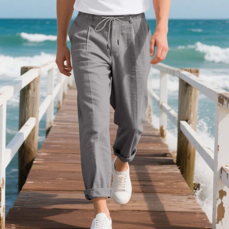Casual men's linen pants in gray, ideal for summer leisure, featuring a drawstring and loose straight fit.