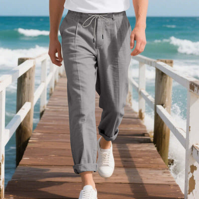 Casual men's linen pants in gray, ideal for summer leisure, featuring a drawstring and loose straight fit.
