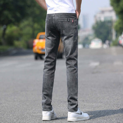 Men's slim straight black gray denim trousers from the back, showcasing a modern casual style.