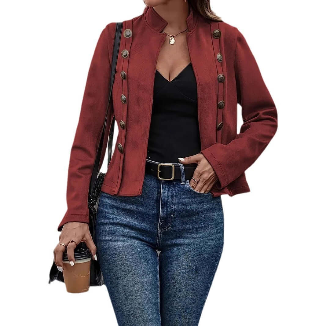 Female wearing a retro long-sleeved coat with metal buttons, styled with jeans and a coffee cup.