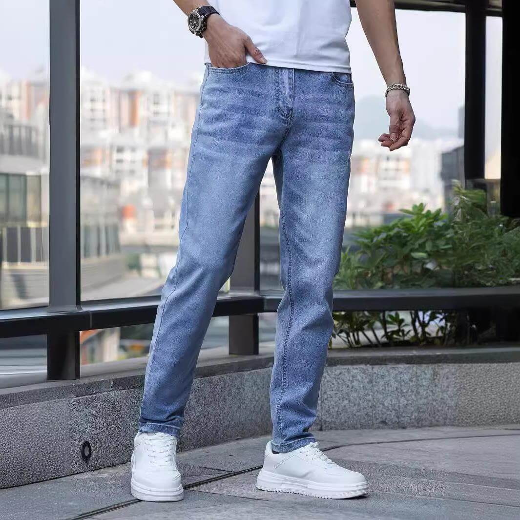 Men's stretch slim jeans in light blue, featuring a mid waist and zip placket, ideal for teenagers and adults.