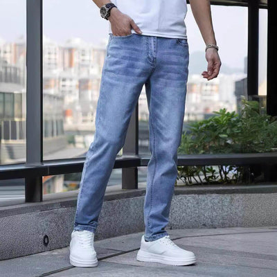 Men's stretch slim jeans in light blue, featuring a mid waist and zip placket, ideal for teenagers and adults.
