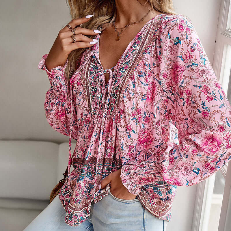 Boho chic long sleeve blouse with floral print and V-neck, featuring lace-up and drawstring details.