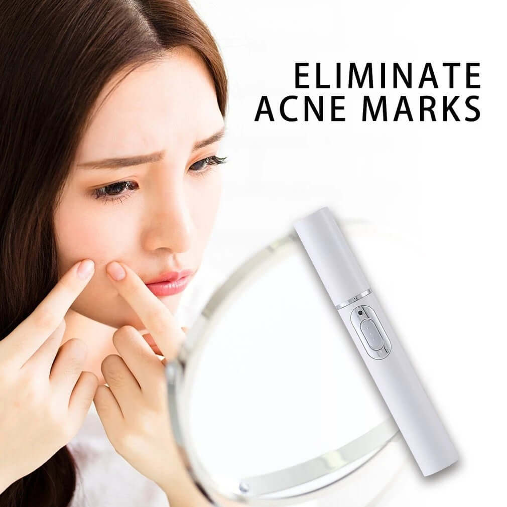 Woman using blue light therapy acne laser pen to eliminate acne marks while looking in a mirror.