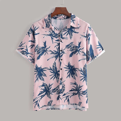 Men's pink short-sleeve shirt with navy palm tree print, perfect for casual summer outings.