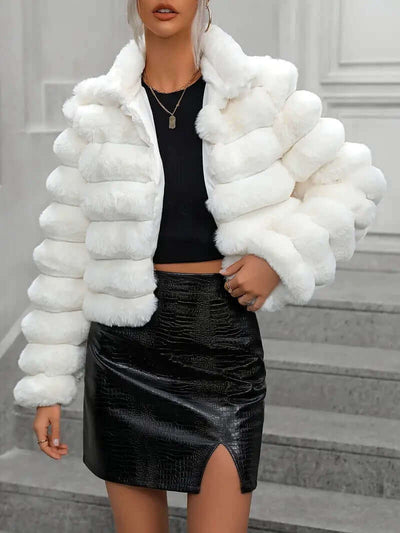 Women wearing a stylish short imitation fur coat in white, paired with a black skirt, perfect for autumn and winter.