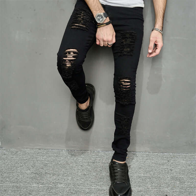 Men's trendy ripped denim jeans in black, featuring a skinny fit and mid waist design, perfect for casual wear.