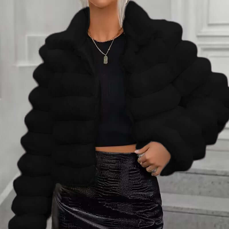 Women wearing a black imitation fur coat with long sleeves and a faux fur collar, styled for autumn and winter.