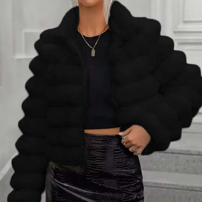 Women wearing a black imitation fur coat with long sleeves and a faux fur collar, styled for autumn and winter.