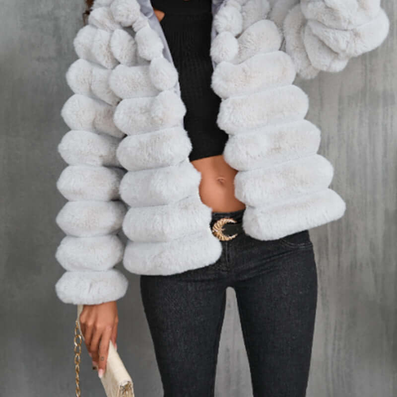 White imitation fur coat with faux fur collar, long sleeves, and stylish puffy design for women.