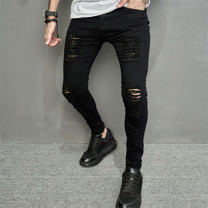 Men's trendy ripped black denim jeans with a skinny fit, featuring distressed details and micro-elastic fabric.
