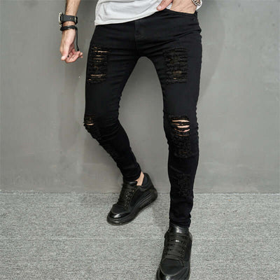 Men's trendy ripped black denim jeans with a skinny fit, featuring distressed details and micro-elastic fabric.