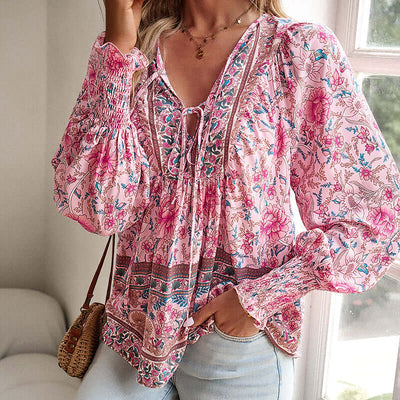 Boho chic long sleeve blouse with floral print and lace-up detail, perfect for vacation and casual wear.