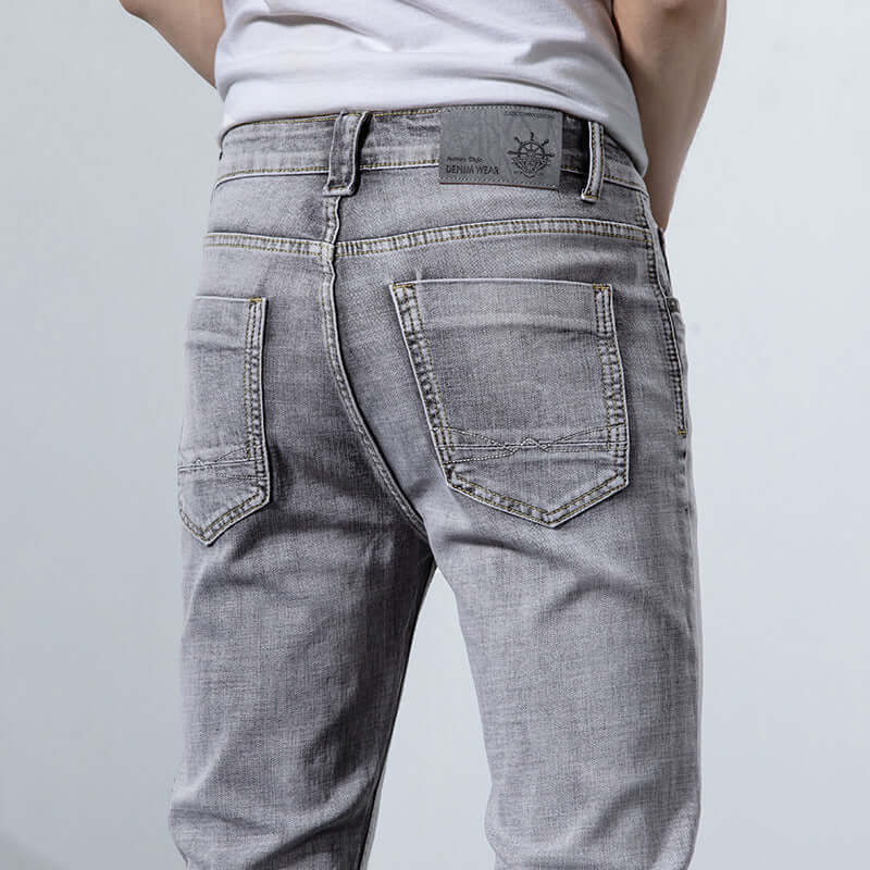 Back view of versatile retro gray jeans for men showcasing mid waist fit and stylish design.