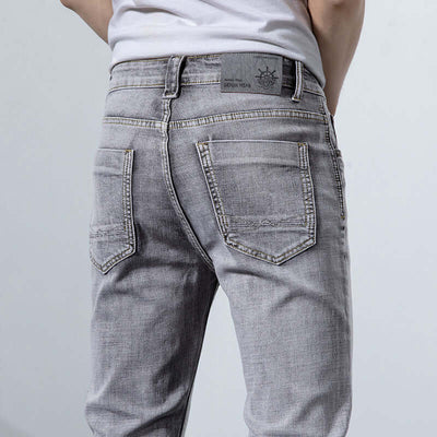 Back view of versatile retro gray jeans for men showcasing mid waist fit and stylish design.