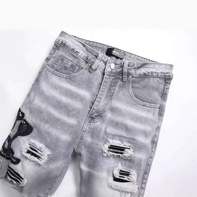 Fashion gray hole patch embroidered cobra stretch men's skinny jeans, featuring a mid waist and micro-elastic fit.