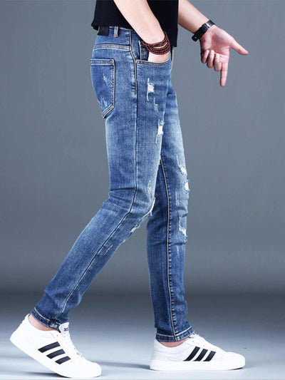 Men's ripped denim jeans in light blue, slim-fit style, perfect for casual wear, featuring distressing and stretch fabric.