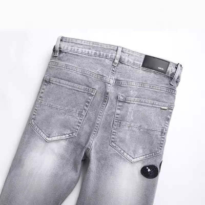 Back view of fashion gray skinny jeans with hole patch embroidery and zip placket, ideal for young adult males.