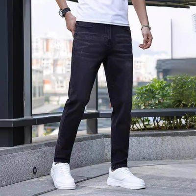 Men's stretch slim jeans in black, perfect for daily wear, featuring a mid waist and zip placket.