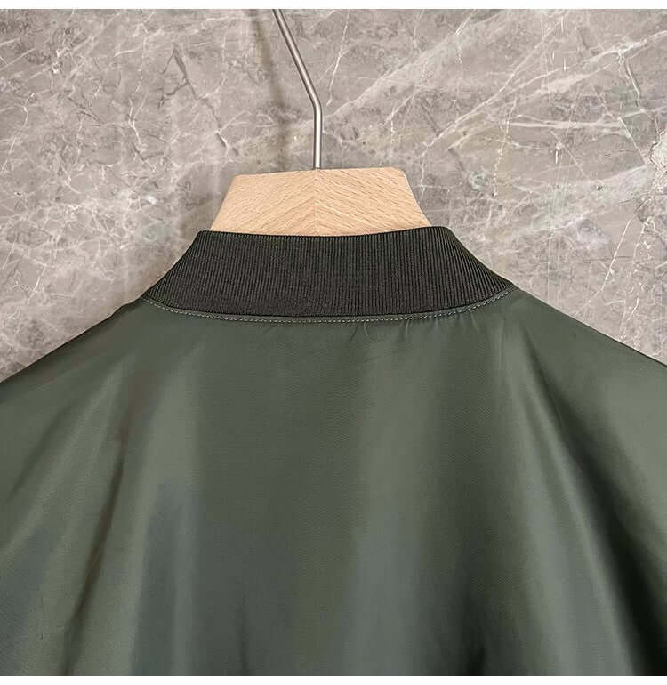 Back view of a loose-fit military green jacket for men with a ribbed collar.