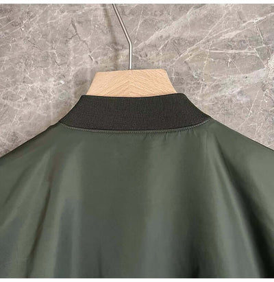Back view of a loose-fit military green jacket for men with a ribbed collar.