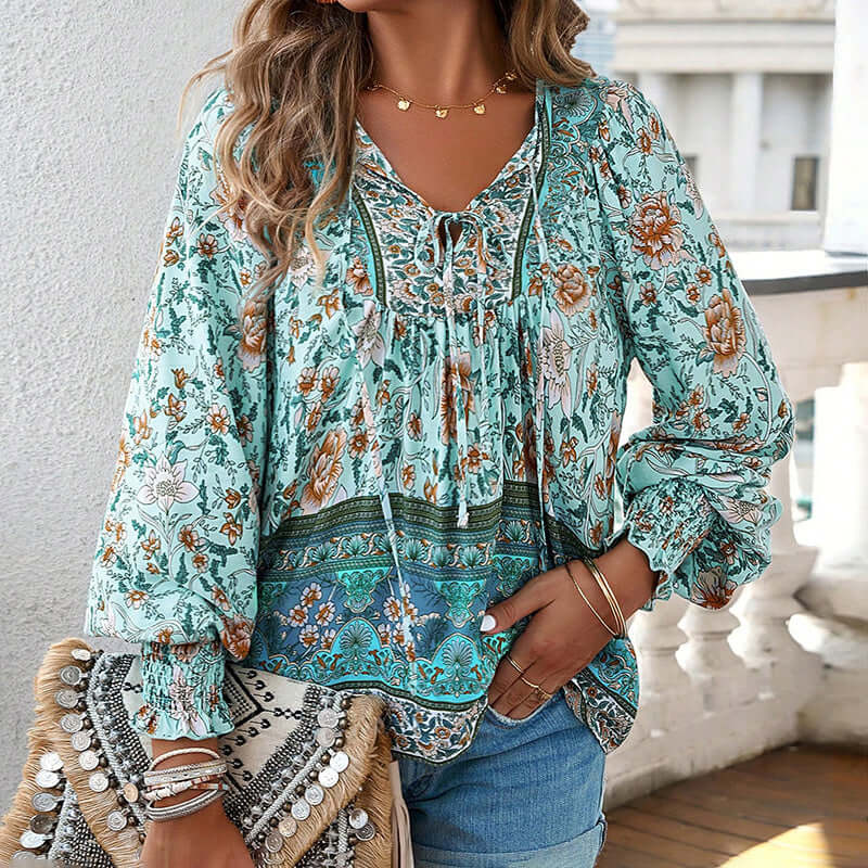 Womens boho chic long sleeve blouse with floral print, V-neck, and lace-up detail, perfect for vacation style.