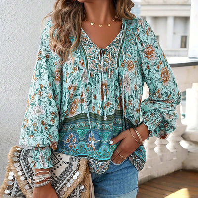 Womens boho chic long sleeve blouse with floral print, V-neck, and lace-up detail, perfect for vacation style.