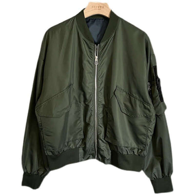 Loose-fit military green bomber jacket for men with long sleeves and pocket details, perfect for autumn outfits.