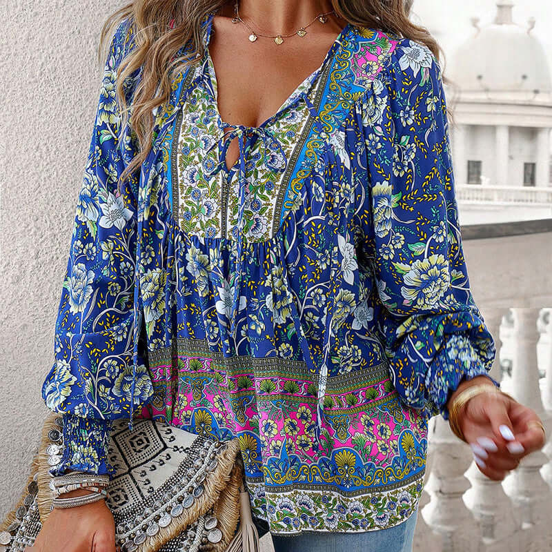 Boho chic long sleeve blouse with floral print, V-neck, lace-up detail, and vibrant colors, perfect for elegant casual wear.