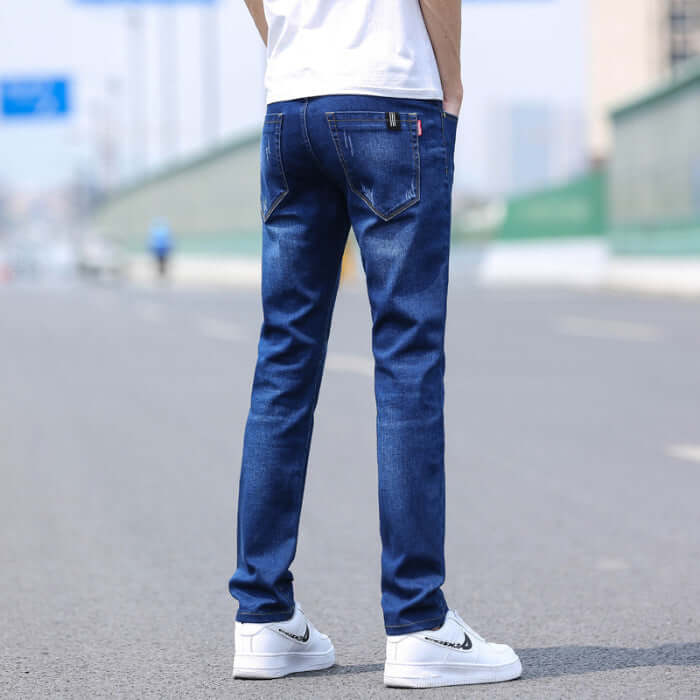 Men's slim straight stretch denim trousers in dark blue, featuring a mid-waist design and thin fabric for spring and summer fashion.