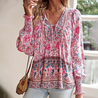 Boho chic long sleeve blouse with floral print and lace-up detail for elegant summer vacations.