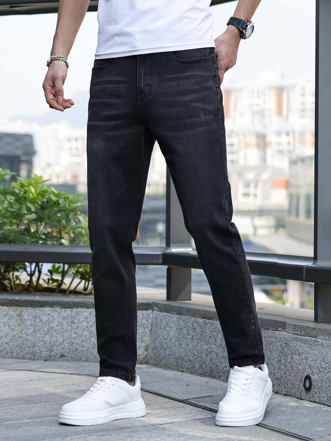 Men's black stretch slim jeans featured in a casual outdoor setting, perfect for daily wear and various occasions.