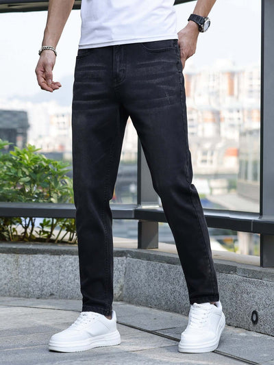 Men's black stretch slim jeans featured in a casual outdoor setting, perfect for daily wear and various occasions.