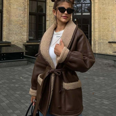 Stylish woman wearing a dark brown Korean style long sleeve splicing coat with fur accents and pockets.
