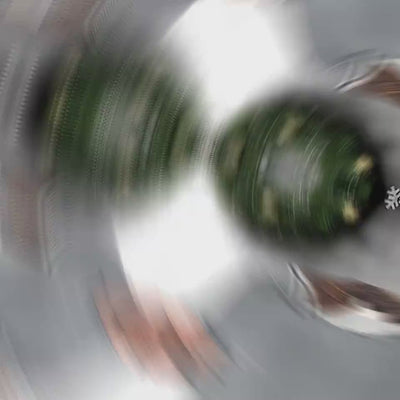 Abstract close-up of a spinning mechanical object with green and silver elements.